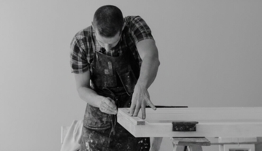 Man doing wood work on door