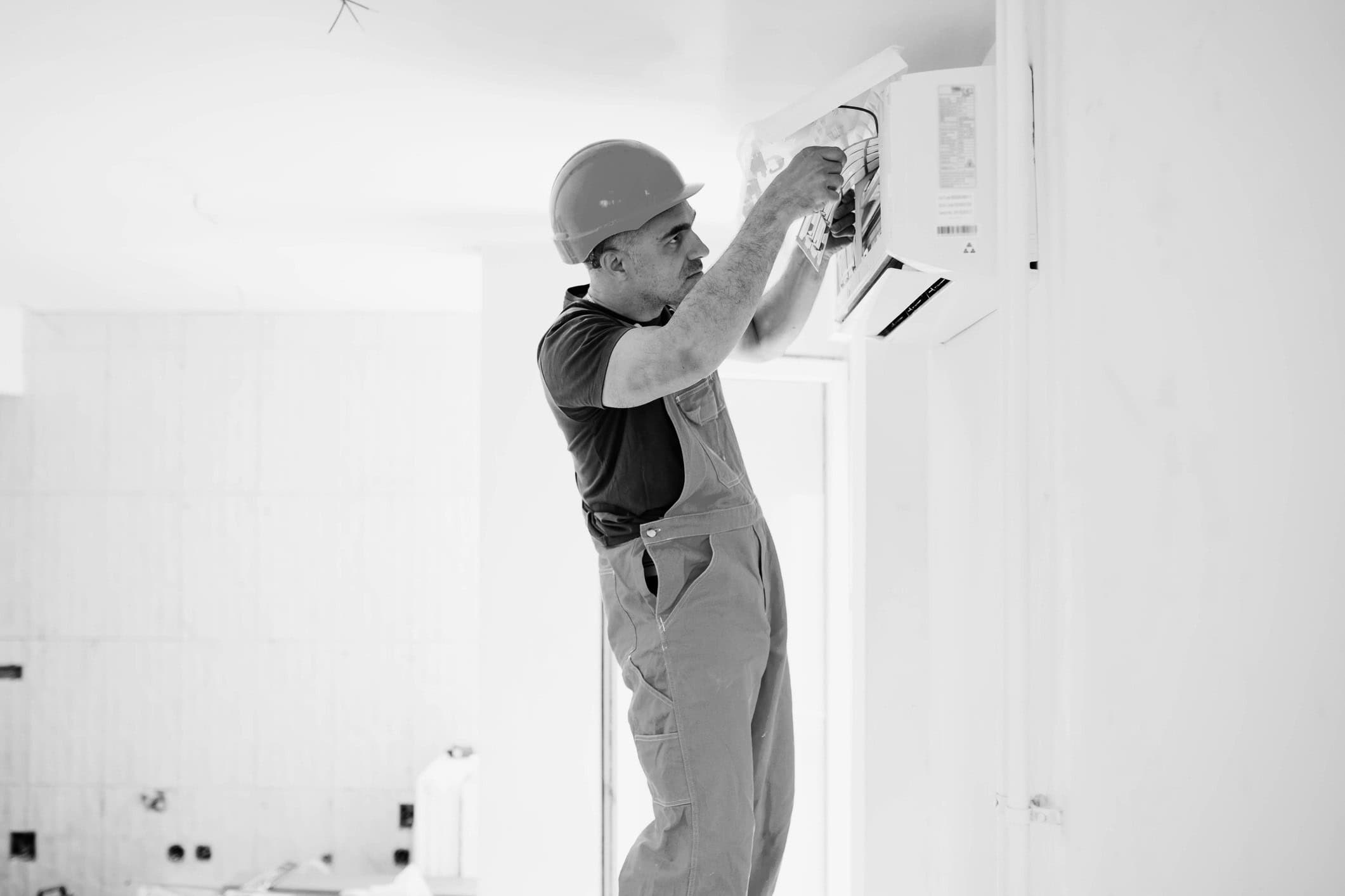 Man fixing air conditioning unit