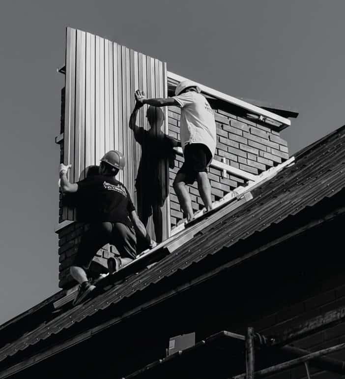 Men fitting some roof panels