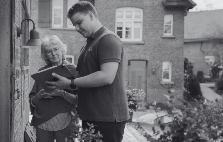 Housing maintenance operative reviewing a scheduled repair with a resident